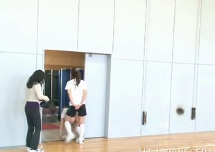 Four hot, built Asian girls playing on a non-reflective near the gym